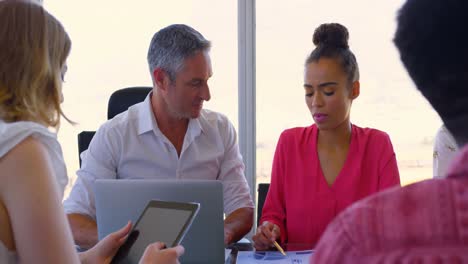 colegas de negocios caucásicos maduros discutiendo sobre gráficos en una reunión en la oficina moderna 4k