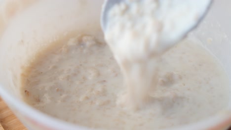 mixing oats, banana and milk in a bowl