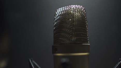 focus shift to a voice microphone in a dark studio environment