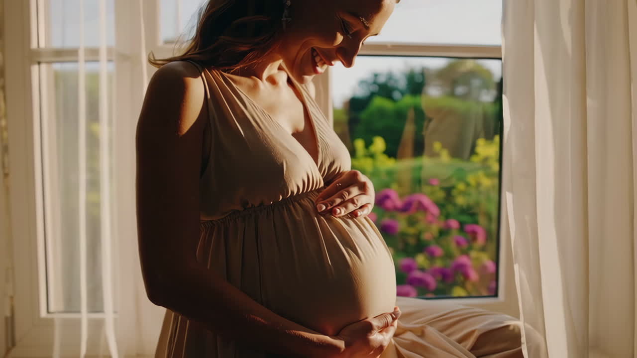 Pregnant woman smiling by the window