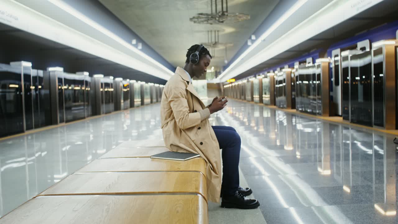 Man Using Mobile Phone at Subway Station