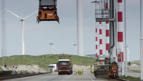 industrial scene at rotterdam port with cranes and wind turbines