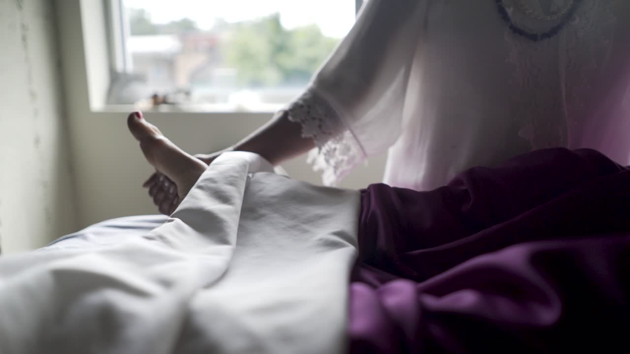 Person receiving a foot massage on a bed