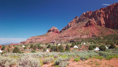 Static-wide-shot-of-desert-yurts-spread-across-the-desert-floor