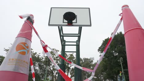 low angle view of an empty colorful basketball court is seen at a closed playground during the covid-19 coronavirus outbreak and restrictions in hong kong