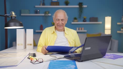 home office worker old man looking at paperwork files.