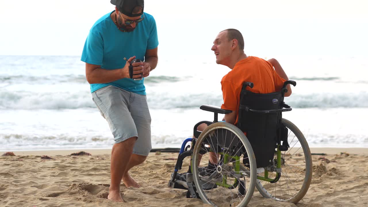 Two Men on Beach with Wheelchair