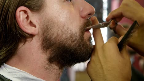 man getting his mustache trimmed in hair salon 4k