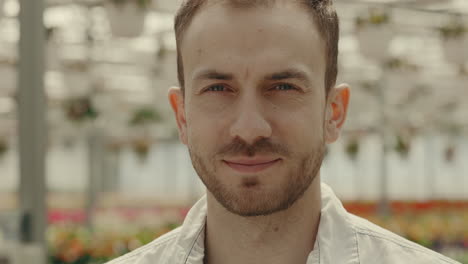 close-up portrait of a man in a greenhouse