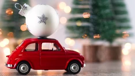 red vintage car with white christmas ornament on the roof