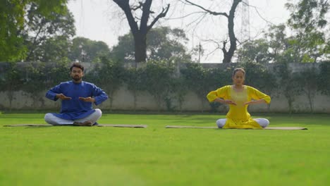 indian couple practicing breathe in breathe out exercise in yoga