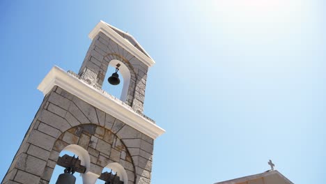 la luz del sol ilumina el campanario de piedra de una iglesia histórica en la isla de corfú