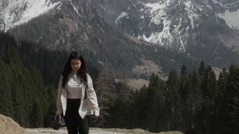 female tourist walking on trail at dolomite mountains in italy