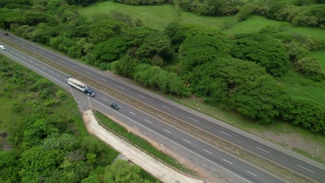 aerial: drone view of a freight truck transporting cargo across rural panama.