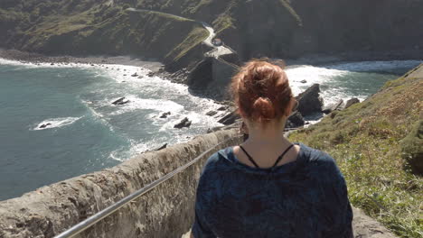 coastal view with a bridge and a woman