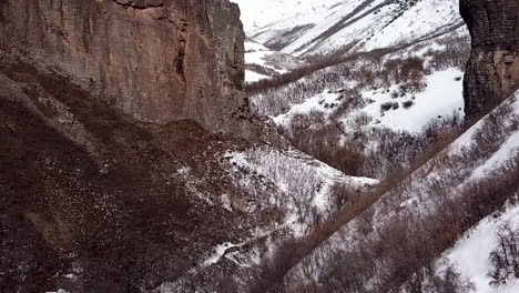 flying between two rugged cliffs in the winter wilderness - dolly zoom parallax