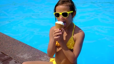 the child eats ice cream near the pool. selective focus. kid.