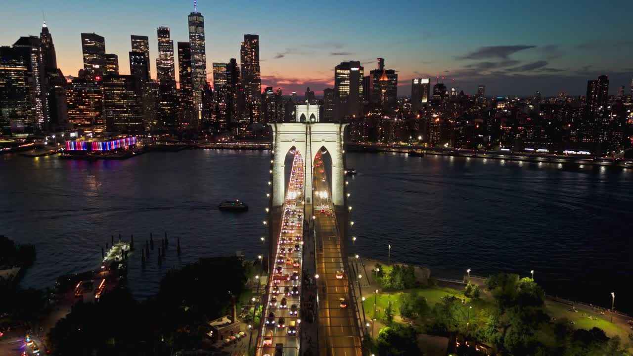 Drone shot of Brooklyn Bridge at dusk with Financial District in the background