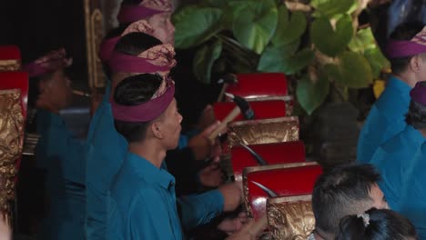 balinese musicians band playing on gangsa instruments during legong and ramayana traditional theater dance performance at ubud palace, bali