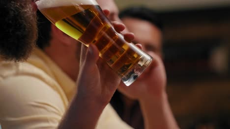 man drinking beer and using mobile phone in the pub