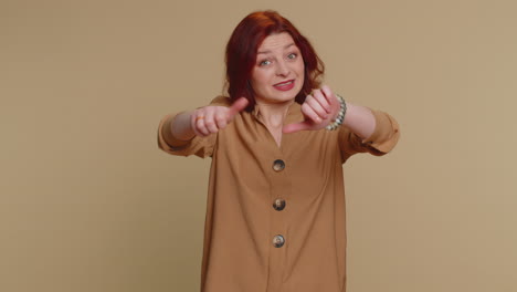 upset young woman girl in blouse showing thumbs down sign gesture, disapproval, dissatisfied dislike