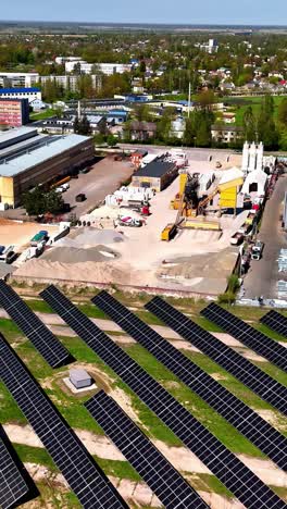 vertical aerial view of an active construction site located beside a large solar panel installation