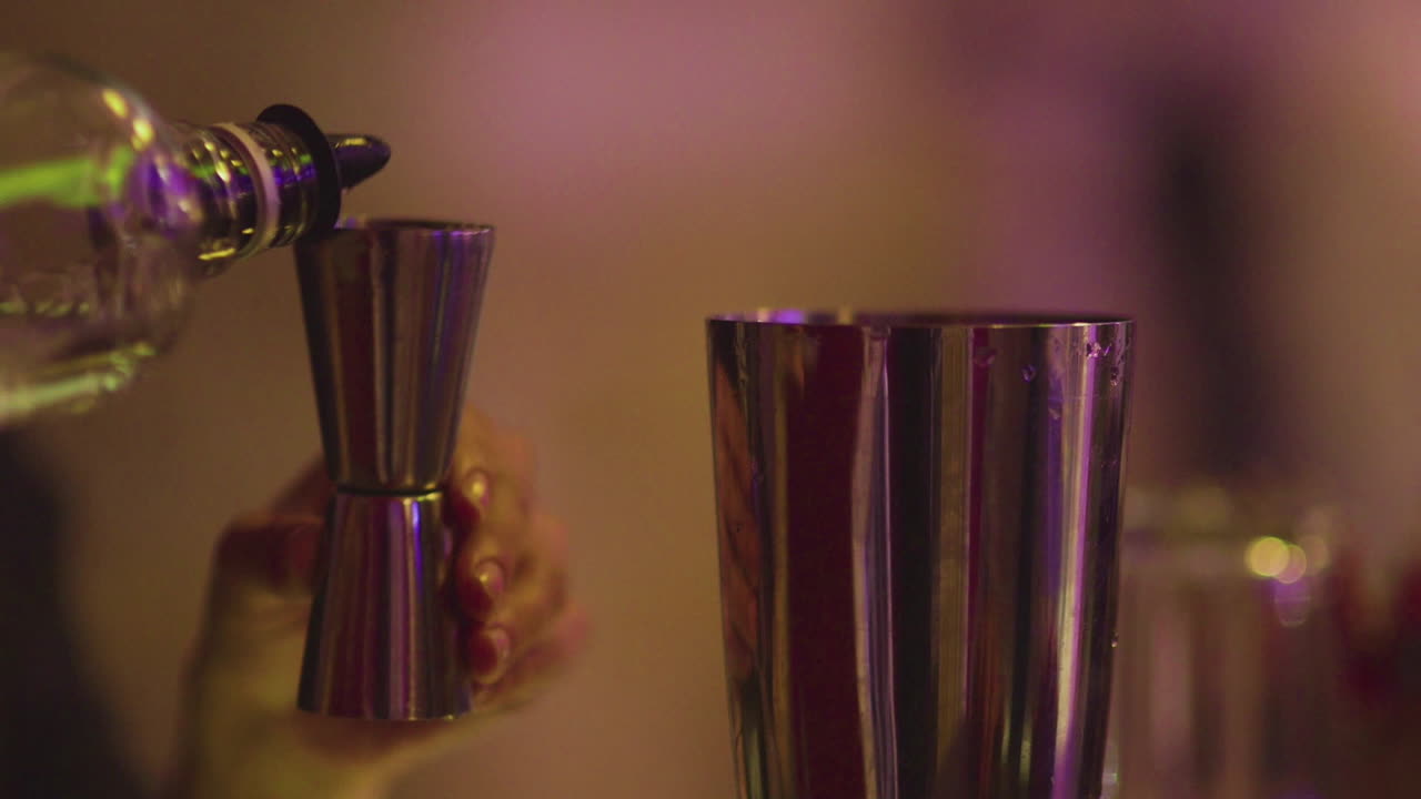 Barman Pours Alcohol Into Drink And Stirs It