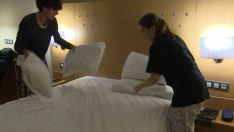 hotel room maid making bed