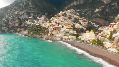 breathtaking drone footage captures stormy day in positano, italy, revealing vibrant hills adorned with colourful houses and buildings