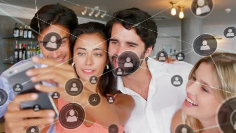 animation of network of connections over caucasian friends taking selfie