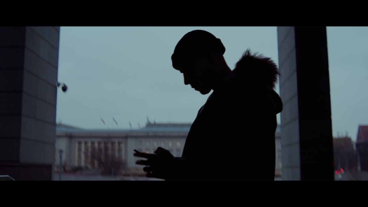 Man using smartphone outdoors in winter