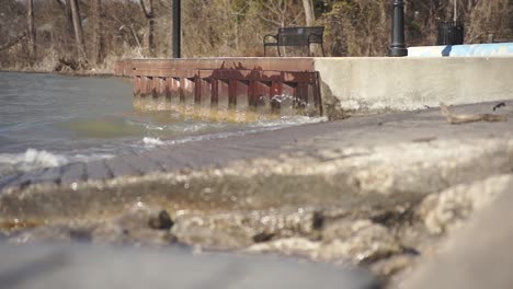 this shows waves crashing on a boat dock at a park