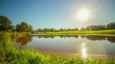 sunrise time lapse clear sky nature field near lake and forest, green hills