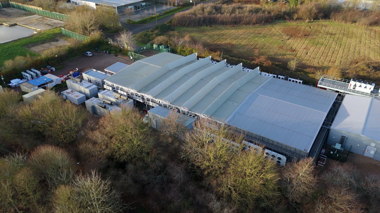 Drone view of server cooling fans and external ventilation components at a Milton Keynes quantum data site.