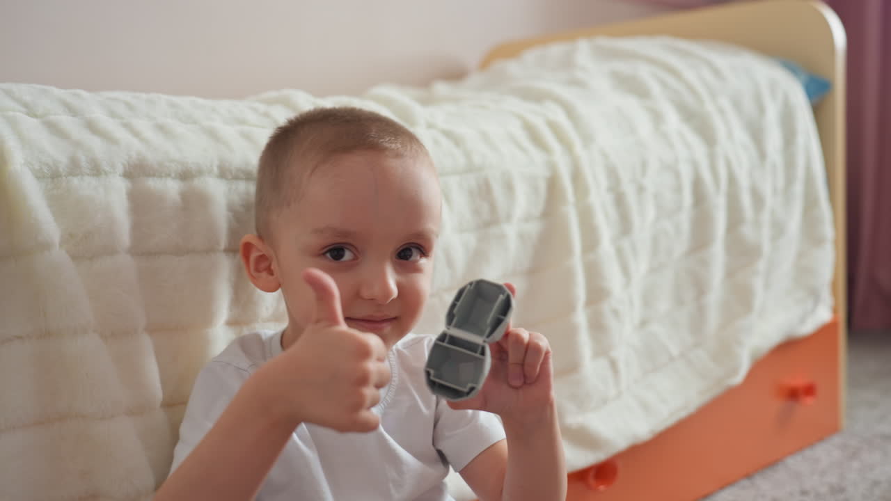 Joven muestra un pequeño triunfo. Un niño pequeño exhibe felizmente su pequeño premio. Un niño entusiasta irradia orgullo mientras demuestra con confianza sus pequeños triunfos de premios