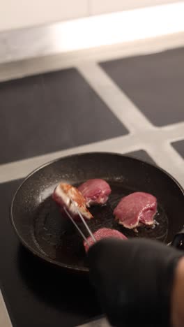 frying steaks in a pan