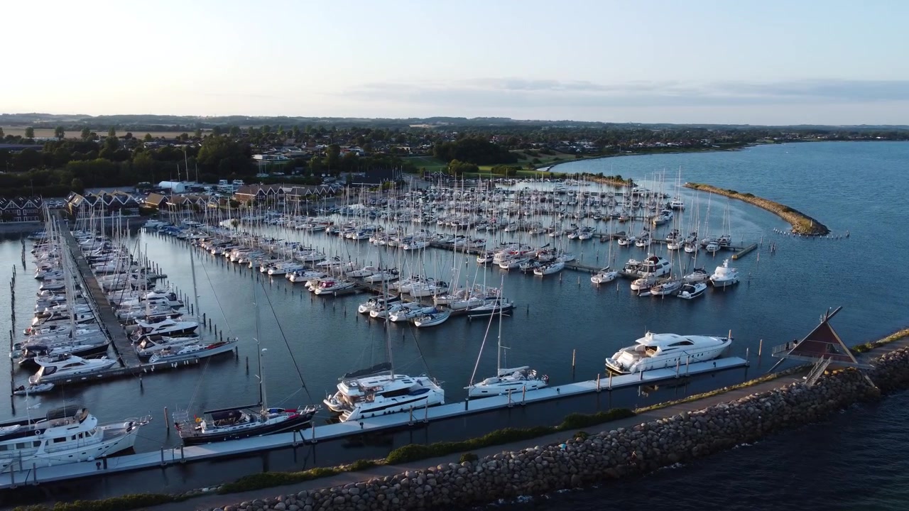 Ega Marina filled with sailboats and docks along the coast near Aarhus, Denmark, aerial