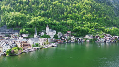 evangelical and catholic churches at hallstatt, austria. - aerial pullback shot