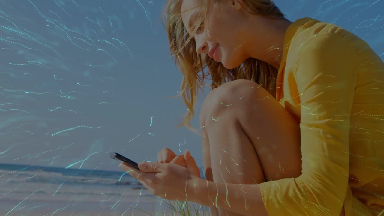 Woman on beach tapping phone initiating waveform turning into burst, fading while smiling for tech