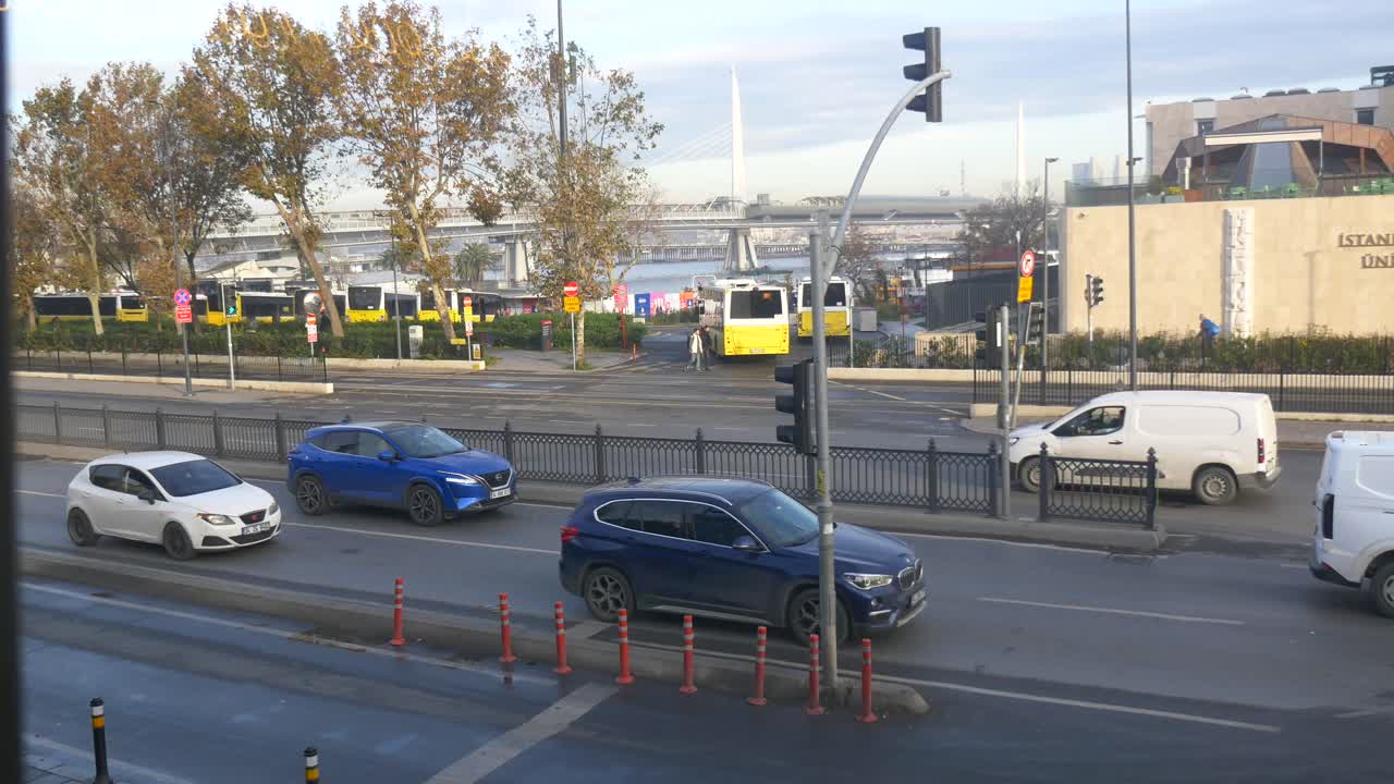 City street scene with cars, buses, and bridge in Istanbul