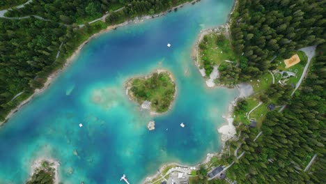 Turquoise-lake-surrounded-by-vegetation-and-trees