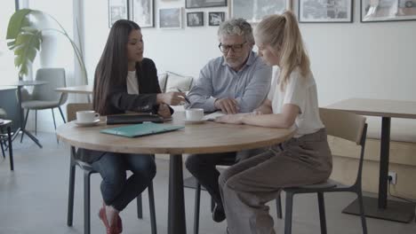 female advisor helping clients to complete document