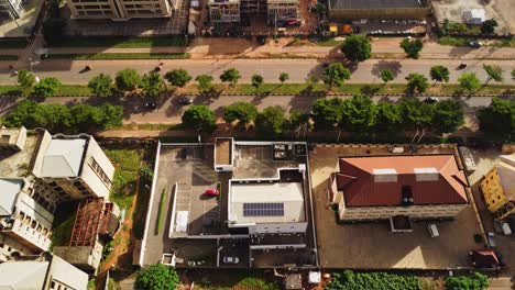 aerial view of a busy road running through the city of abuja, nigeria. the drone reveals a variety of buildings in the african capital