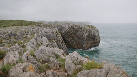 coastal cliffs under a cloudy sky