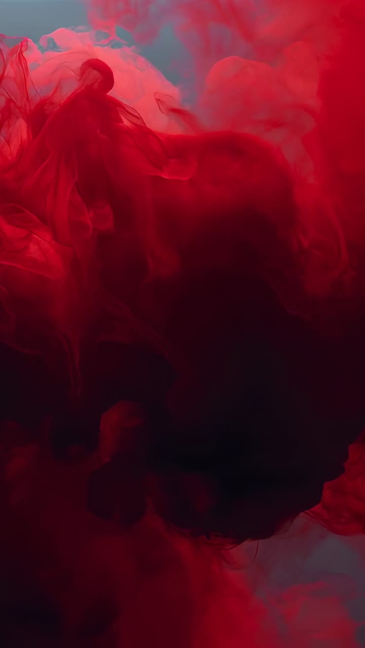 Video verticale: nube emergente di pigmento rosso che si espande in alto a sinistra in un serbatoio trasparente retroilluminato, che mostra il nucleo