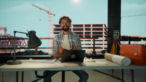 happy engineer or architect working on construction site plans