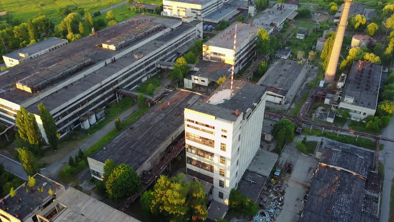 Old Industrial Factory Buildings. Vintage old big factory with closed door and broken windows