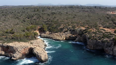 sea lagoon wedged between rock cliffs eroded by sea waves in mallorca