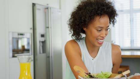 front view of black mother wiping her daughters mouth with a napkin cloth 4k