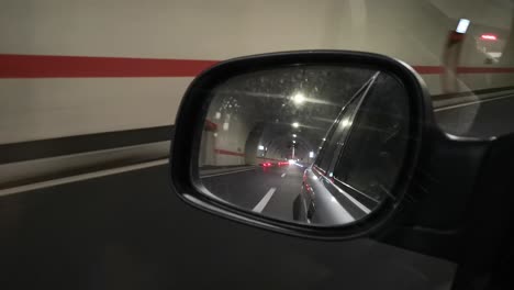 passing through the highway tunnel and looking in the rearview mirror